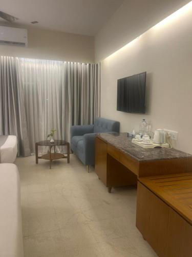 a living room with a couch and a television at Hotel Kollol by J&Z Group in Cox's Bazar