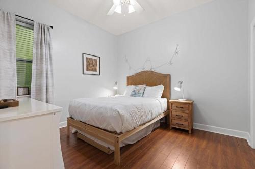 a white bedroom with a bed and a dresser and a window at Happy Days - Seagrove Highlands in Santa Rosa Beach