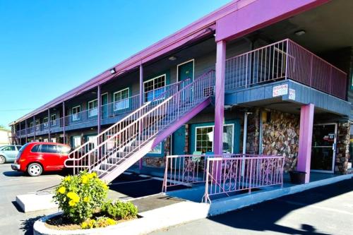 a building with purple stairs in a parking lot at Beaverton Budget Inn in Beaverton