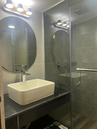 a bathroom with a sink and a mirror at Hotel Kollol by J&Z Group in Cox's Bazar