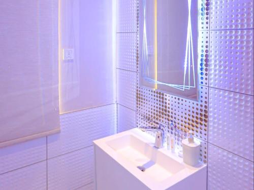 a white bathroom with a sink and a mirror at Skylight Guest Lodge in Johannesburg