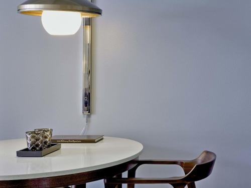 a table with a lamp and two chairs at Fairmont El San Juan Hotel in San Juan