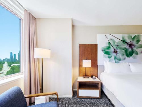a hotel room with a bed and a window at Fairmont Chicago Millennium Park in Chicago