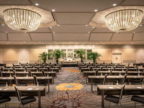 a banquet hall with tables and chairs and chandeliers at Fairmont Chicago Millennium Park in Chicago