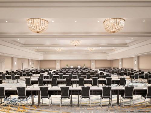 a large room with tables and chairs and chandeliers at Fairmont Chicago Millennium Park in Chicago