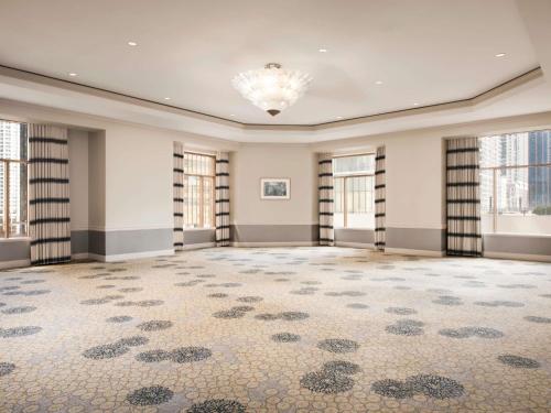 an empty room with windows and a large rug at Fairmont Chicago Millennium Park in Chicago