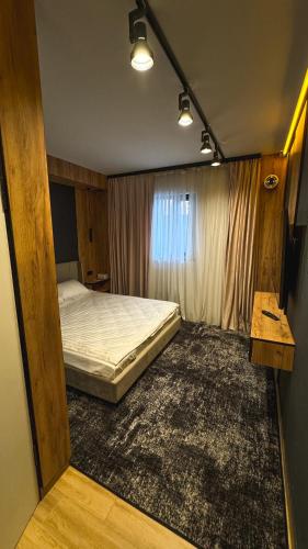 a small bedroom with a bed and a window at Hostel Olevsk in Olevsk