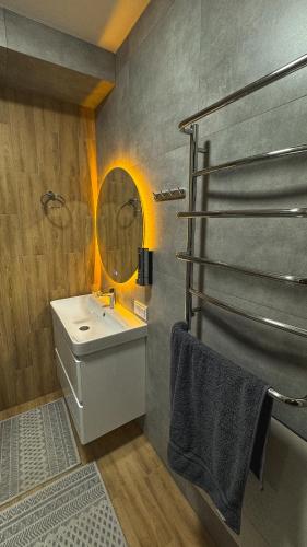 a bathroom with a sink and a mirror at Hostel Olevsk in Olevsk