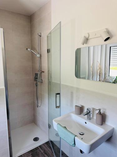 a bathroom with a sink and a shower at FeWo S26 in Krumbach