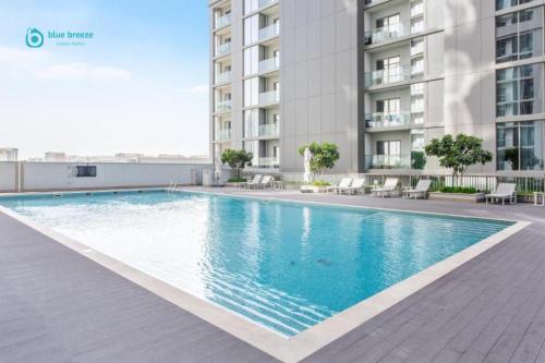 a swimming pool on the roof of a building at Blue Breeze - 2 Bedroom near Downtown, Elegant Retreat in Sobha in Dubai