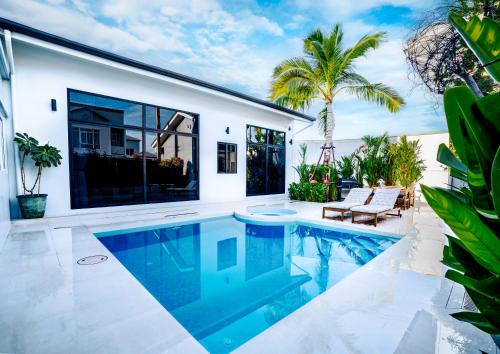 a swimming pool in the backyard of a house at Bangkok Luxury Private Pool & Jacuzzi Villa , Daily Maid in Bang Bua Thong