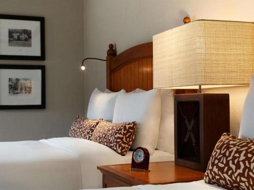 a hotel room with a bed and a lamp at Fairmont Jasper Park Lodge in Jasper