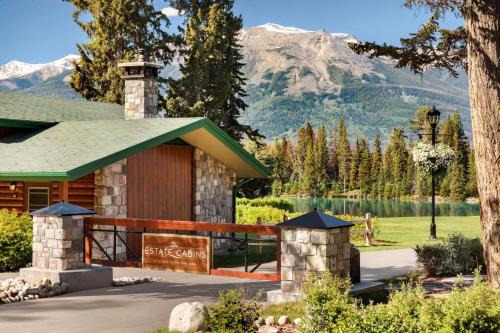 a resort building with a mountain in the background at Fairmont Jasper Park Lodge in Jasper