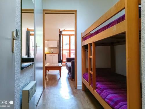 a bedroom with a bunk bed with purple sheets at Studio avec balcon, parking et Wi-Fi au cœur de Brides-les-Bains - FR-1-512-266 in Brides-les-Bains