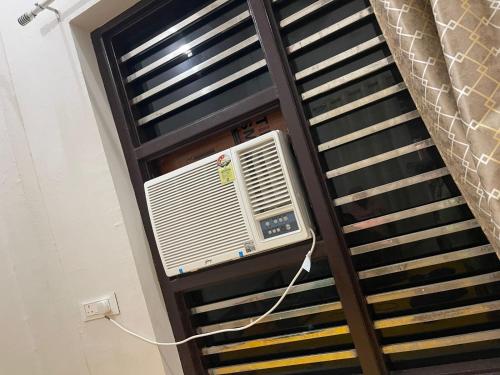 an air conditioner on a window in a building at Sankant Mochan Ashram in Toda Bhīm