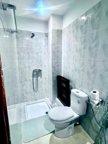 a bathroom with a toilet and a shower at Oasis Gueliz Center Marrakech in Marrakesh
