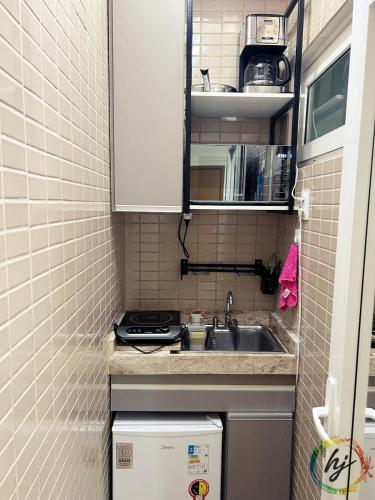 a small kitchen with a sink and a stove at Paradise Flat 114 in Nossa Senhora do Livramento