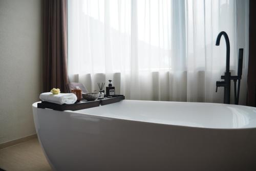 a white bath tub in a room with a window at year after year in Lijiang