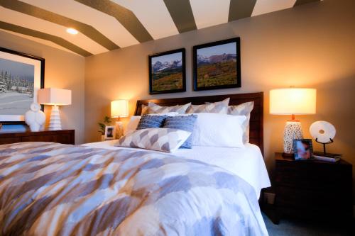 a bedroom with a large bed with two lamps at The Precesion Palace Hotel Near IGI Airport in New Delhi