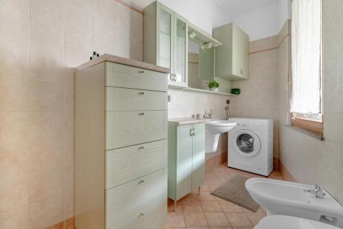 a bathroom with a sink and a washing machine at New - RhoFiera Milano - 5 min Free Wi-Fi in Rho