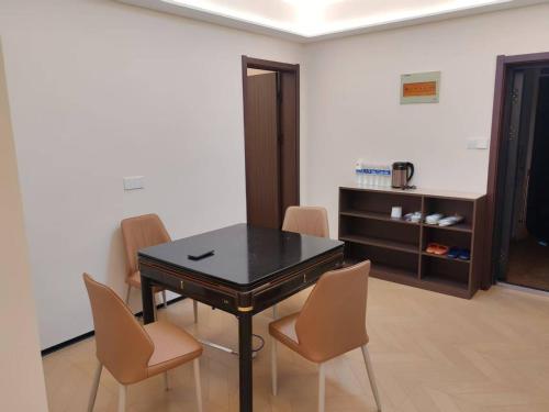 a dining room with a black table and chairs at Fenghe Cottage 