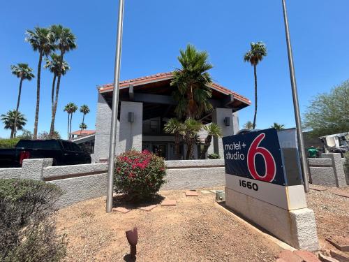 a mobiloco sign in front of a building with palm trees at Motel 6 Tempe, AZ Elliot Road in Tempe