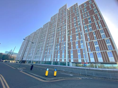 a large building with yellow parking meters in front of it at Bracknell RWH Spectacular Two Bedroom Apartment in Bracknell