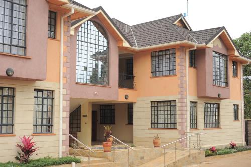 a house with a large window at Davis Court in Nyeri