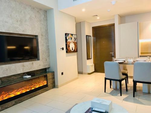 a living room with a fireplace and a television at STAY BY LATINEM Luxury 2BR Holiday Home CV B2513 near Burj Khalifa in Dubai
