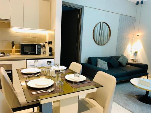 a kitchen and a living room with a table and chairs at STAY BY LATINEM Luxury 2BR Holiday Home CV B2513 near Burj Khalifa in Dubai