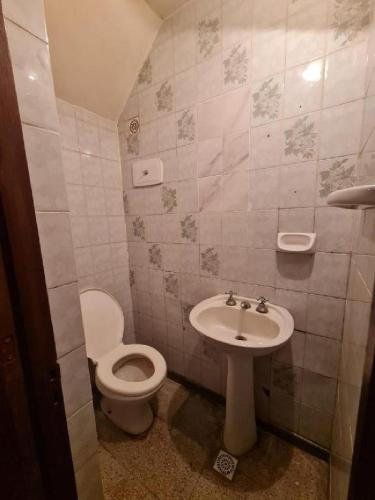 a bathroom with a toilet and a sink at Casa Centro Santiago in Santiago del Estero