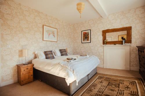 a bedroom with a large bed and a mirror at Stone House Wales in Kington