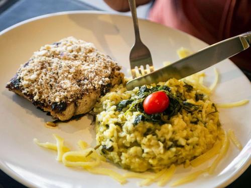 a white plate of food with a fork and pasta at Ed. Connext Loft (ref. Hotel Mercure Boulevard) in Curro Velho