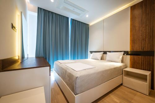 Postel nebo postele na pokoji v ubytování Bellemond Hotel & Residences