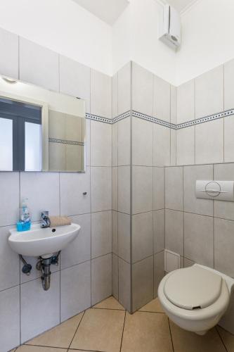 a bathroom with a toilet and a sink at GRAND ADVENTURE BUDAPEST in Budapest