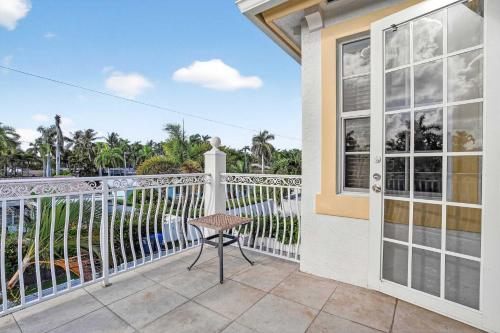 a balcony with a table and a window at Hollywood Crest by Rove - 4BR Home with Heated Pool in Hollywood Beach