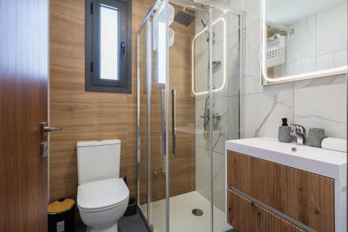 a bathroom with a toilet and a shower and a sink at Vervana 2-Bedroom Apartment in Larnaca