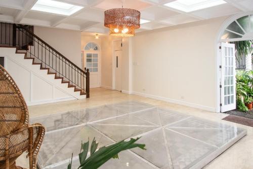 an empty living room with a glass floor at MiraNamin Nest LIRYO Suite in Unique Historic Home - Garden Access, Family Friendly, Shared Kitchen in Manila
