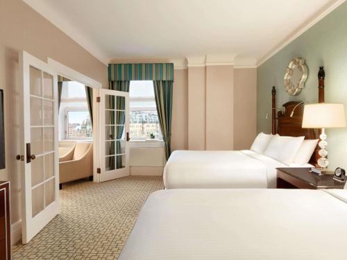a hotel room with two beds and a window at Fairmont Chateau Laurier in Ottawa