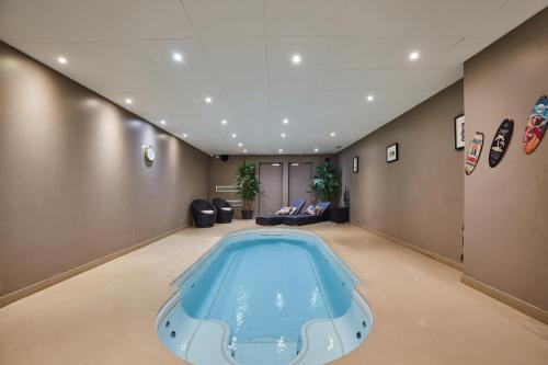 a large swimming pool in a room with a large room at Appart Hotel Odalys City Paris XVII in Paris