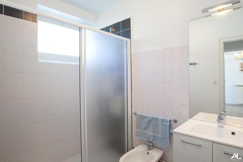 a bathroom with a shower and a toilet and a sink at La poterie in Castets