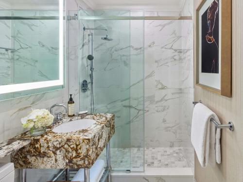 a bathroom with a sink and a shower at Fairmont Hotel Vancouver in Vancouver