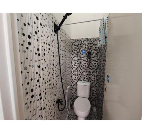 a bathroom with a shower with a toilet in it at OYO 94790 Putri Bungsu Residence in Jakarta