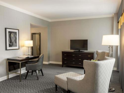 a hotel room with a desk and a television at Fairmont Olympic Hotel in Seattle