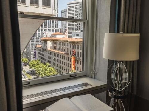 a window in a hotel room with a view of a city at Fairmont Olympic Hotel in Seattle