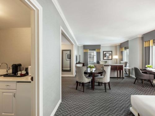a living room with a table and a dining room at Fairmont Olympic Hotel in Seattle