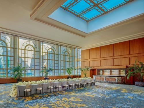 a row of tables in a room with windows at Fairmont Olympic Hotel in Seattle