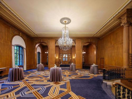 a large room with tables and a chandelier at Fairmont Olympic Hotel in Seattle