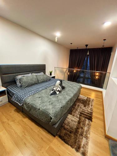 a bedroom with a bed with a stuffed animal on it at MLH Designer Duplex Suite @ EkoCheras in Cheras
