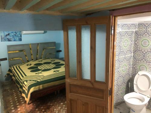 a bedroom with a bed and a toilet at Backpackers Riad in Fès